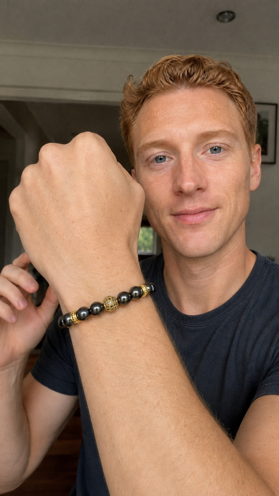 Man pointing to a Zeus Gold hematite bracelet
