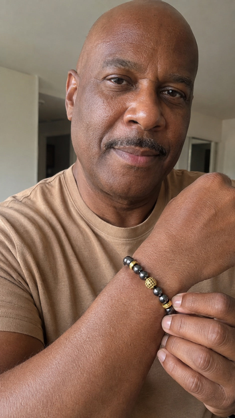 Man wearing a Zeus Gold hematite bracelet